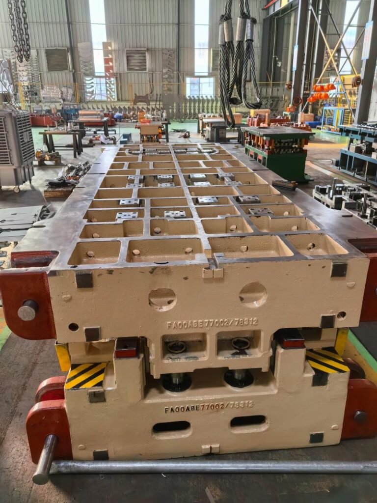 Large die casting mold being lifted in factory, showing serial number and structural details prior to transport. Ready for pre-shipment inspection.