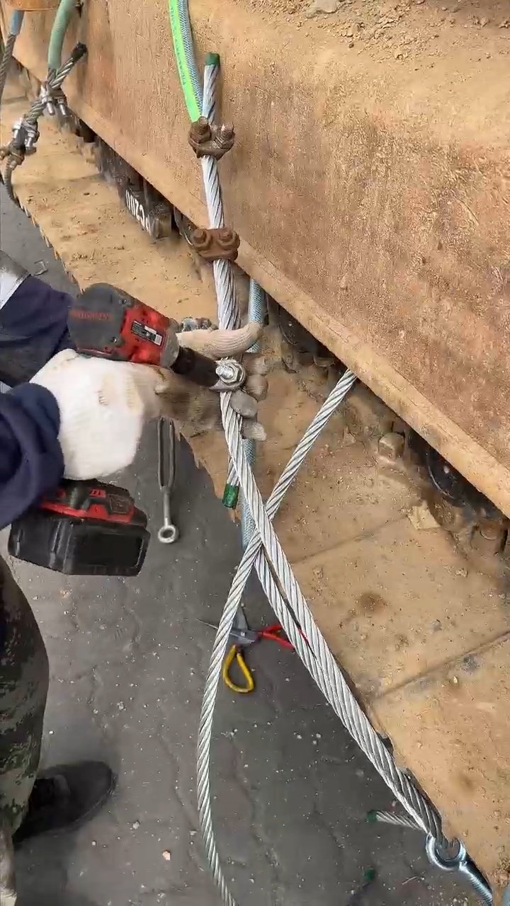 Heavy equipment secured with chains for OOG logistics shipment