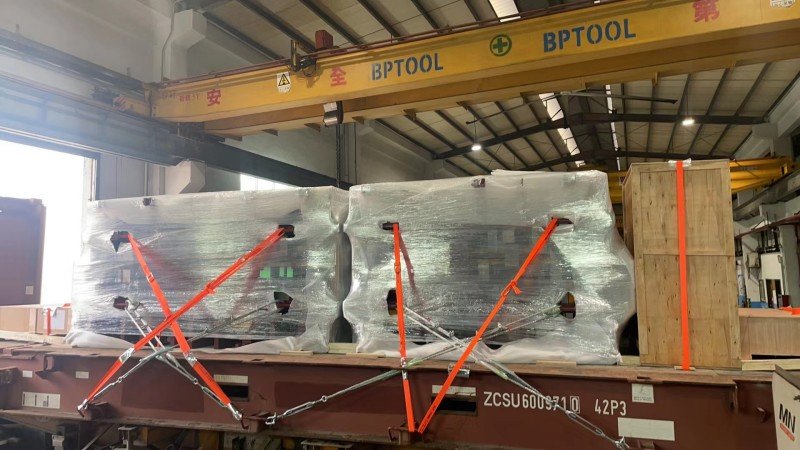 Multiple oversized cargo units stabilized on a trailer with blocking and bracing to maximize contact area and prevent tipping.