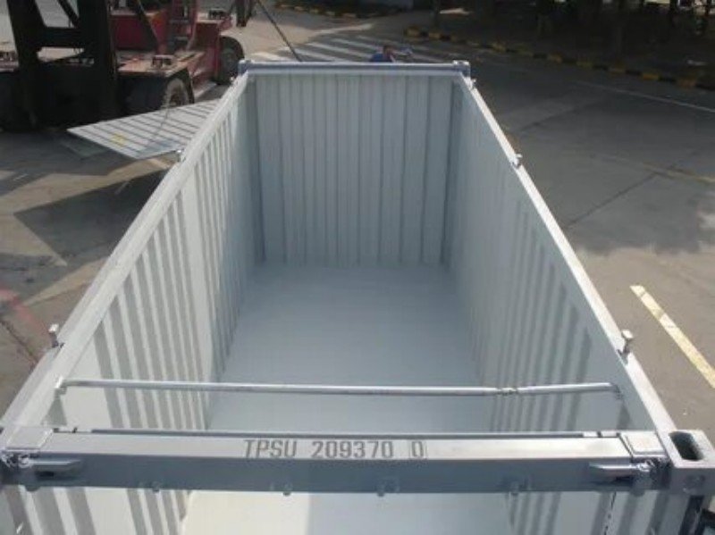 Top-down view inside an empty white open top container showing floor cross members and top rail structure, essential for planning balanced weight distribution and engineering-based lashing plans
