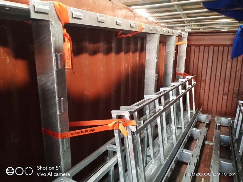 Steel frames installed along the side walls of an open top container for structural support during heavy cargo transport