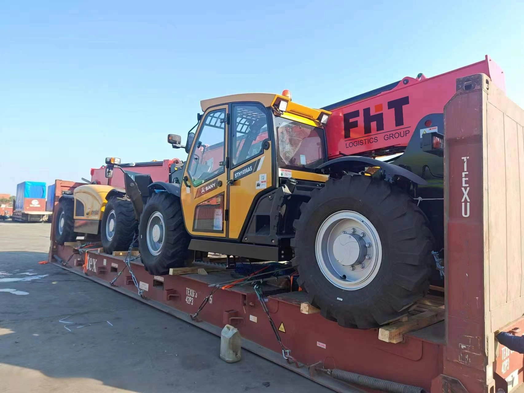 Two yellow Sany telehandlers are loaded side-by-side on a long flat rack container, demonstrating efficient space utilization for bulk heavy equipment transport.