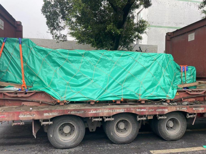 Over-Width Cargo Secured on Flat Rack Trailer for Sea Transport