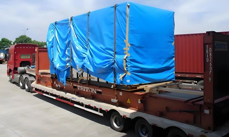 Logistics inspector verifying the stability and lashing tension of an excavator on a flat rack container before loading onto a cargo vessel for international shipping.