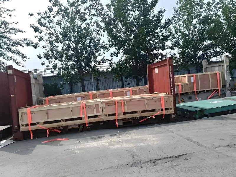 A forklift or crane loading cargo into an Open Top container from the top, compared to cargo being loaded onto a Flat Rack container from the side, demonstrating the impact of loading methods on shipping costs.