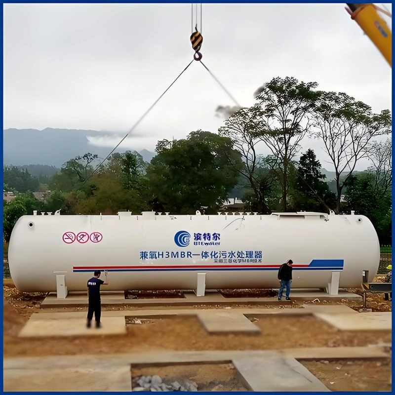 Large white cylindrical H3MBR integrated sewage treatment equipment being lifted by crane at construction site, featuring Mitsubishi chemical MBR technology