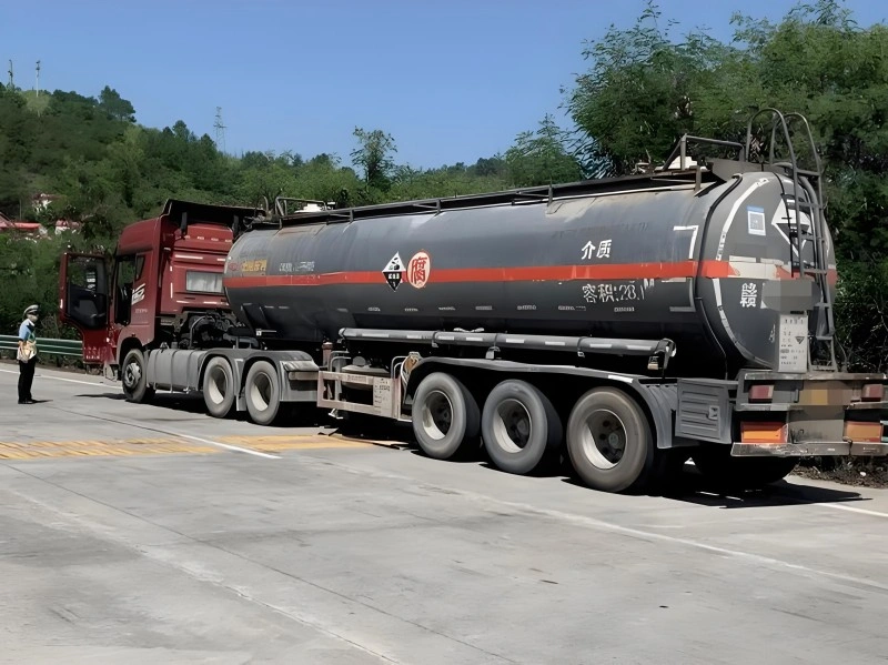 A heavy-duty tanker truck carrying hazardous chemicals, utilizing IoT tracking devices to ensure compliance and safety during the transport of dangerous goods.