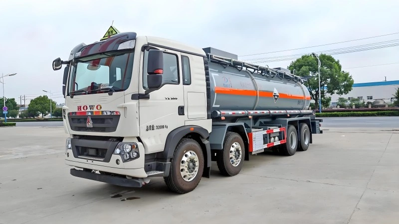 A white Howo 8x4 heavy-duty truck equipped with a large, cylindrical tank for transporting corrosive liquids like hydrochloric acid and sodium hydroxide. The tanker features a protective polyethylene lining and is designed for safe road transport of hazardous materials.
