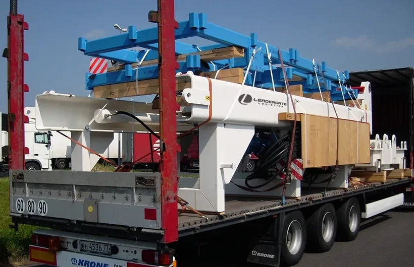 Heavy industrial machinery loaded on flatbed trailer for factory relocation and manufacturing logistics