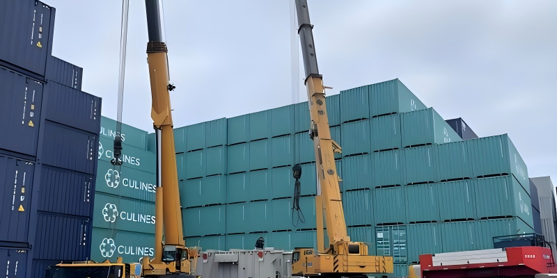 Two mobile cranes operating at port yard beside stacked CULINES and COSCO shipping containers for OOG cargo handling and container loading