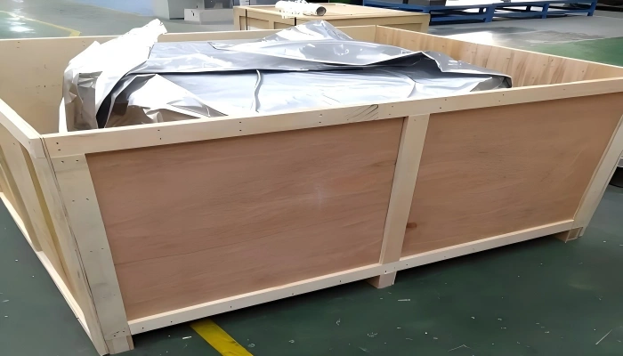 Open top wooden crate lined with silver moisture barrier film and equipped with internal blocking for humidity sensitive cargo protection