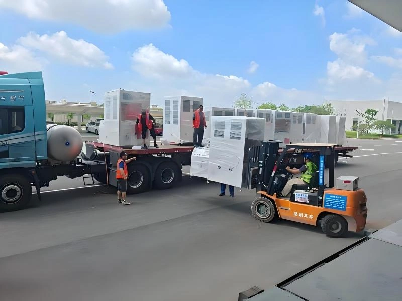 Oversized industrial cargo loaded on ultra-low flatbed trailer for OOG transport as part of a complete production line relocation.