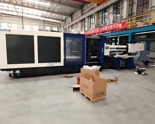 HAITIAN CNC machining center in factory setting, being prepared for export packing and open top container shipment