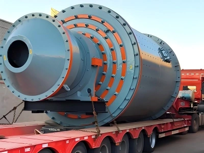 Heavy industrial crusher or mill with reinforced ring structure secured on a red flatbed trailer for oversized cargo transport
