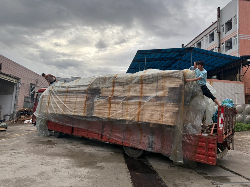 A heavy-duty plywood crate base with timber framing sits on a factory floor, prepared for packing sensitive industrial machinery to ensure stability and protection during international shipping.