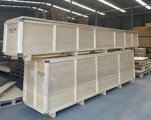 Stacked long wooden cases with internal framing and partition supports prepared for multi-unit machinery shipment