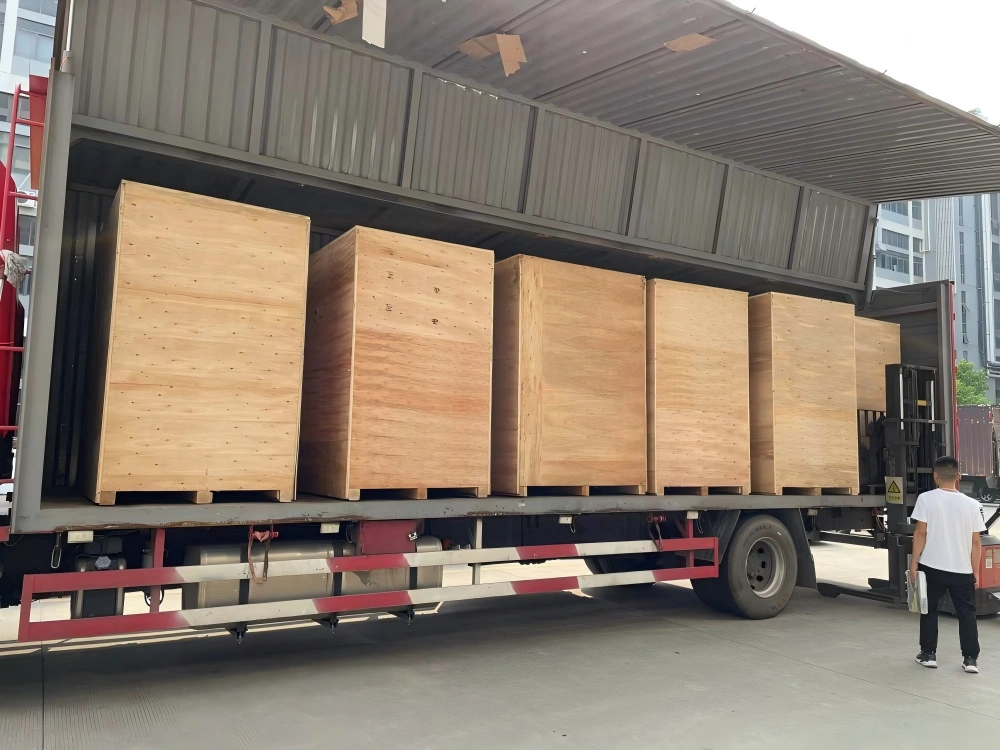 Five custom wooden crates secured on flatbed trailer ready for inland transport as part of oversized project cargo shipment