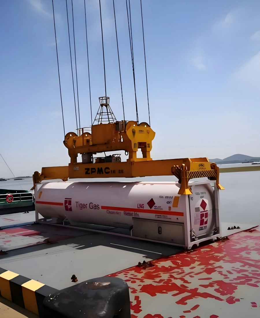 ZPMC spreader lifting white Tiger Gas ISO tank container with LNG hazard placards UN 1978 and Class 2.1 markings onto vessel deck for maritime transport of hazardous cargo