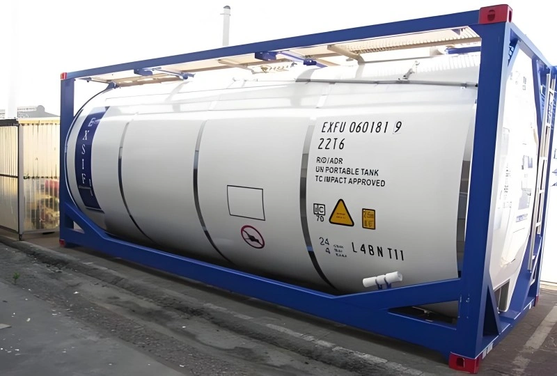 White ISO tank container with blue frame showing UN portable tank specifications and safety markings for shipping hazardous liquids.