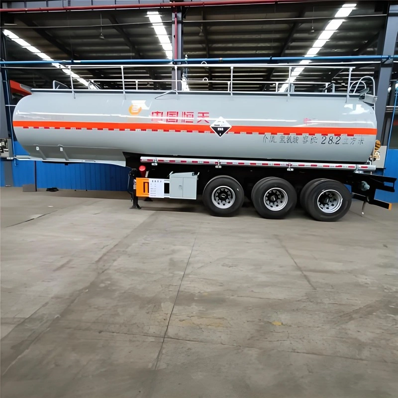 A gray tanker trailer with orange hazard stripes and Chinese characters indicating 28.2 cubic meters capacity, designed for transporting corrosive chemicals with integrated IoT sensors for real-time condition monitoring.