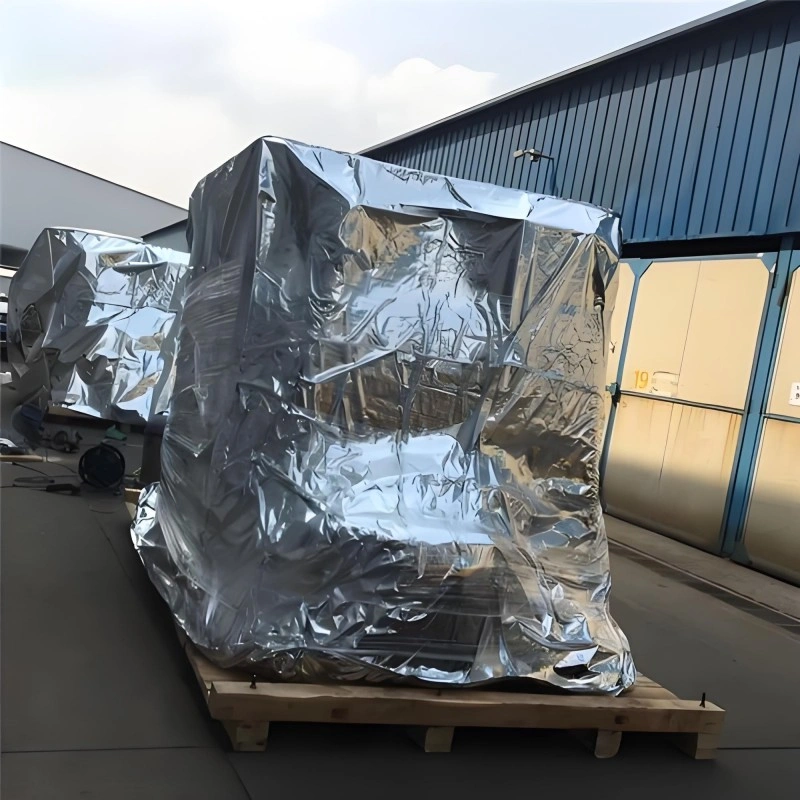 Precision equipment sealed inside a custom-shaped silver aluminum foil vacuum bag on a pallet base, preventing oxidation and contamination for high-value exports.