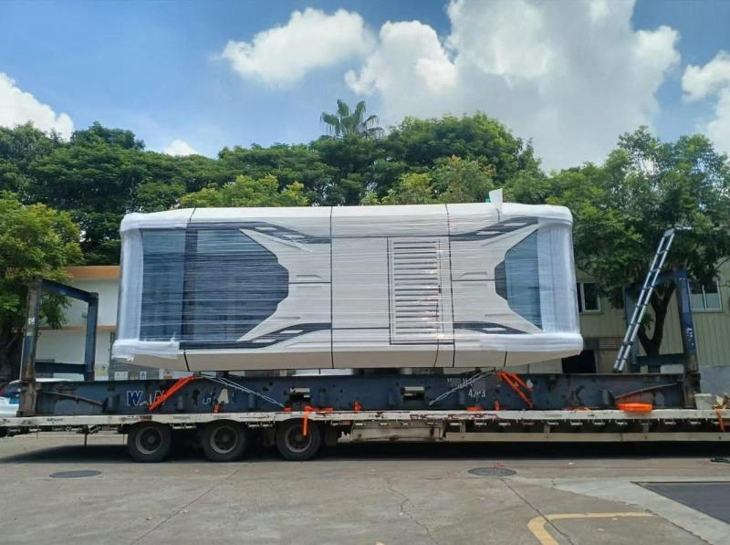 A large prefabricated space cabin module securely mounted on a flatbed trailer, with safety straps ensuring stability during transport.