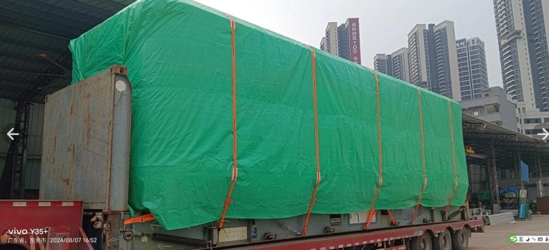 Rear view of a completely covered oversized load on a heavy-haul trailer, showcasing the final stage of cargo preparation before departure to ensure safety and compliance.