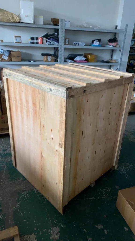 Closed custom-built plywood export crate with reinforced corner posts, showcasing complete enclosure for weather protection and structural integrity
