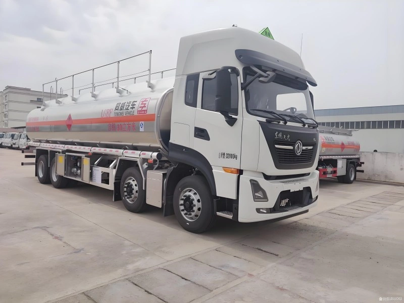 A white Dongfeng Tianlong fuel tanker truck with a 30 cubic meter capacity, featuring advanced safety markings and structural design suitable for oversized cargo transport under digital twin-assisted planning.
