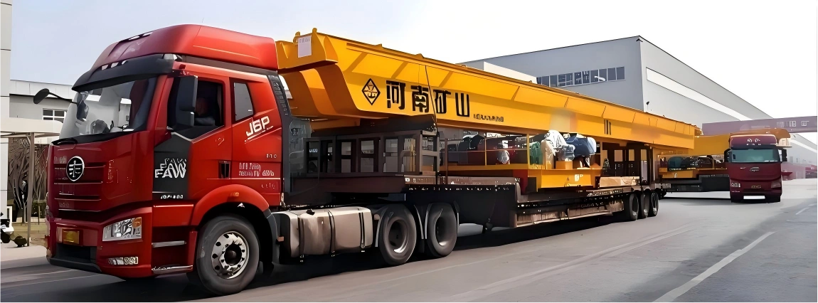 Red heavy-duty truck transporting a massive yellow mining crane structure on a multi-axle trailer, showcasing a tailored flat rack logistics solution.