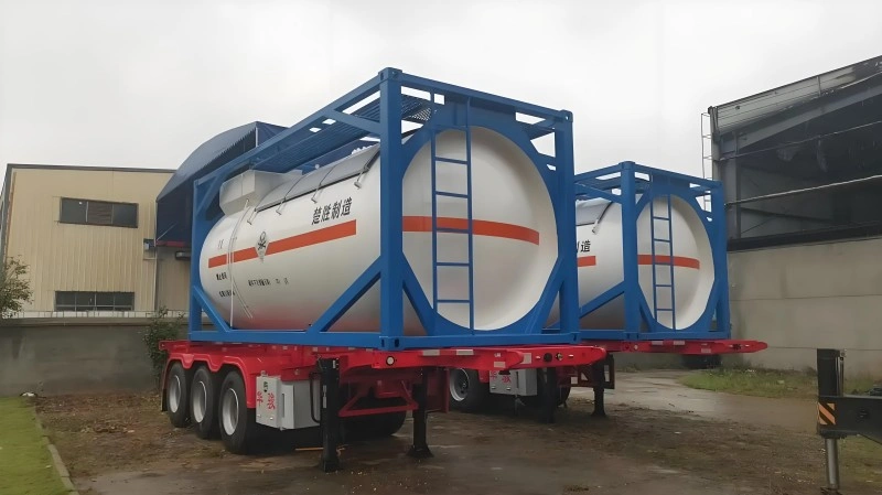 Two large ISO tank containers mounted on a red trailer, used for transporting hazardous chemicals