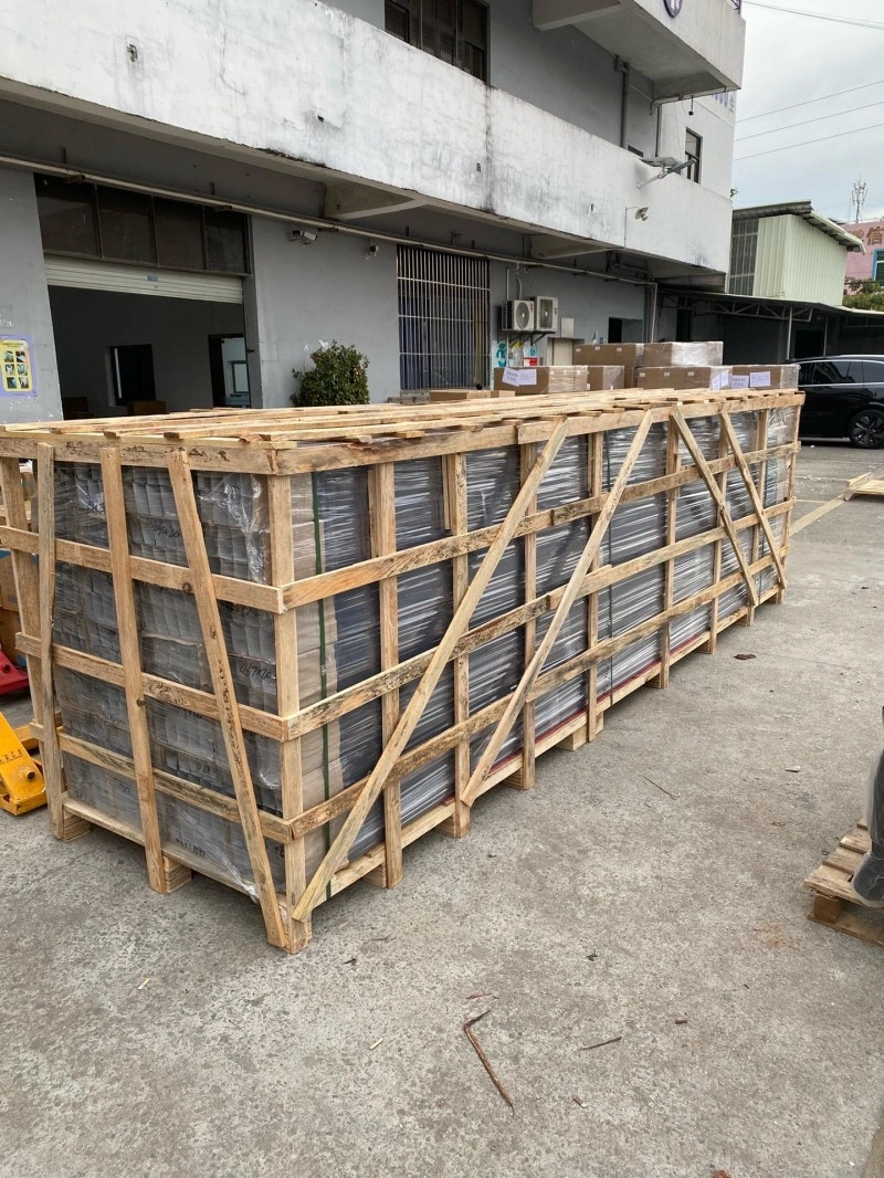 Large wooden crate with visible structural bracing and plastic-wrapped industrial equipment inside, ready for international shipping under ISPM 15 standards
