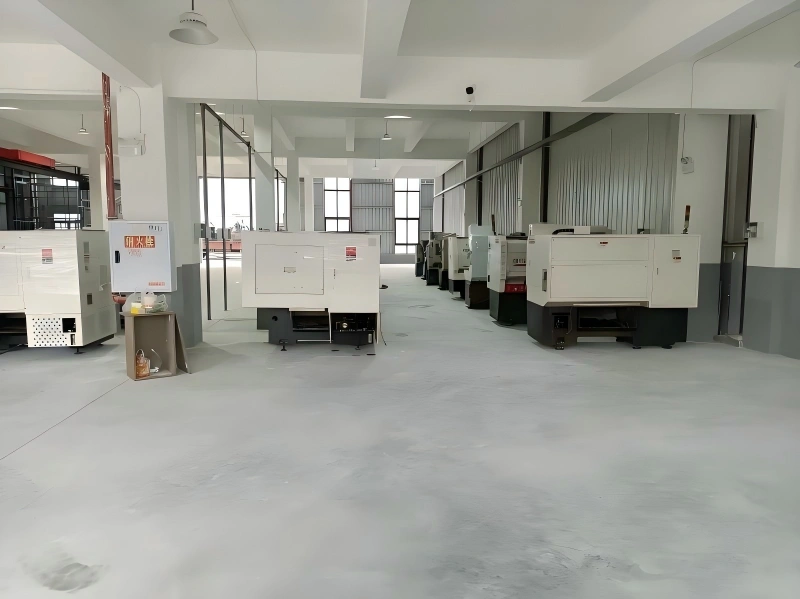 Newly installed white CNC machines aligned in a clean factory workshop with epoxy flooring, showcasing professional industrial machinery relocation.