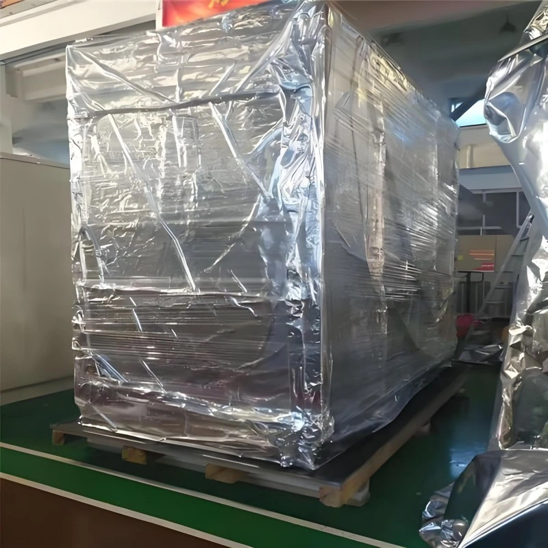 High-value CNC or mold equipment fully enclosed in shiny aluminum composite vacuum bag, resting on reinforced wooden base inside warehouse, ready for international shipment.