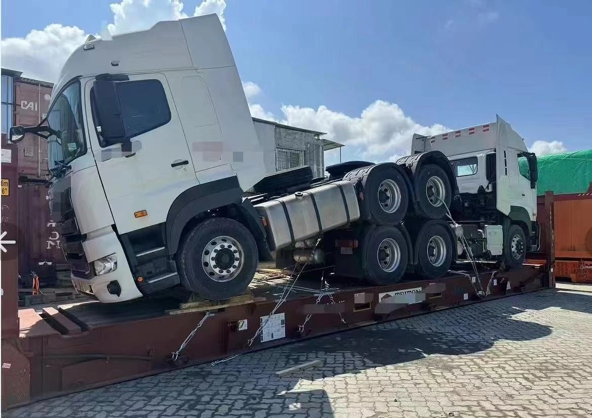 Side profile of dual tractor units stowed on a specialized transport frame, demonstrating the logistical challenges that require advanced scheduling to mitigate risks.