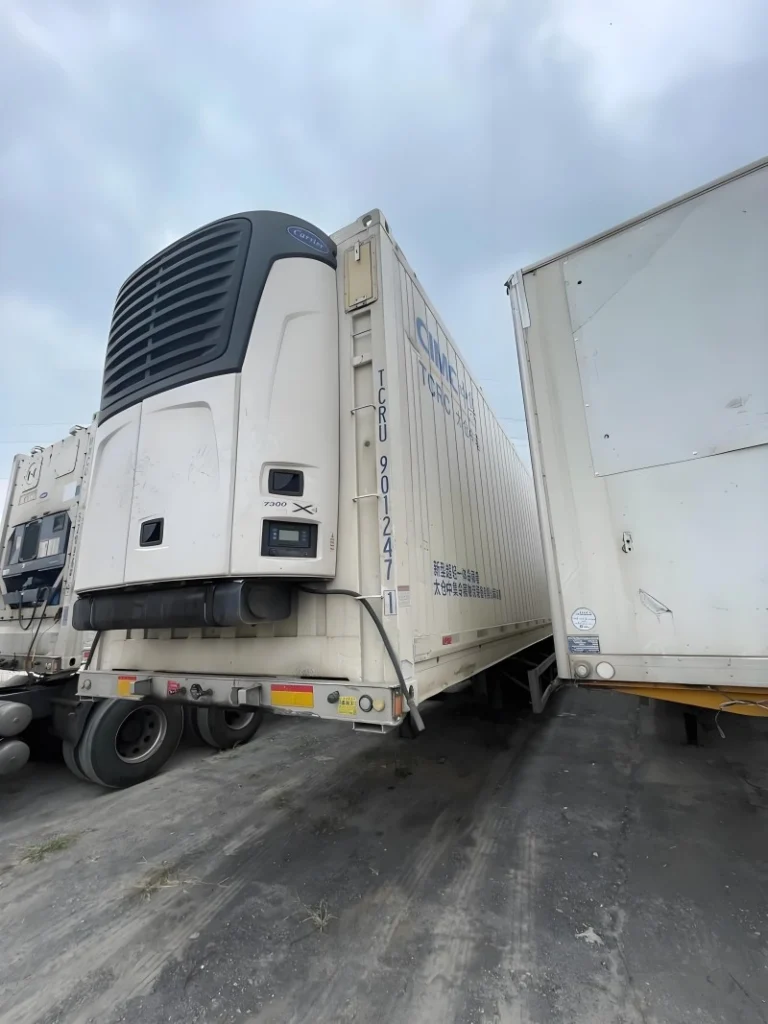 Reefer container being handled at port for international temperature-controlled cargo transportation